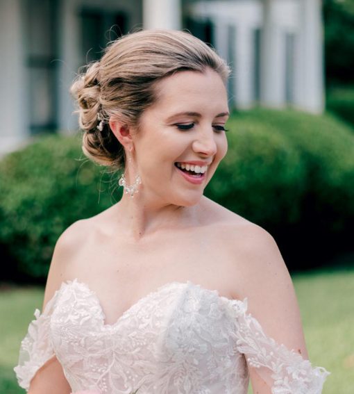 Bride in chandelier earrings made with silver and pearl by Carrie Whelan Designs