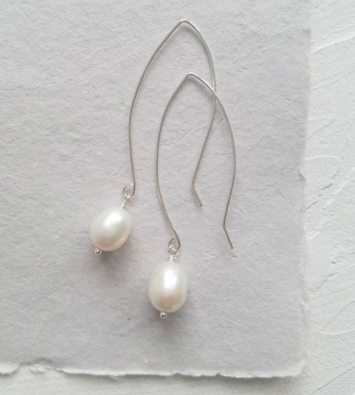 Large pearl long wire earrings in silver for bridal jewelry handmade by Carrie Whelan Designs