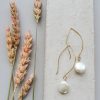 Long dangle coin pearl earrings in 14kt gold fill handcrafted by Carrie Whelan Designs